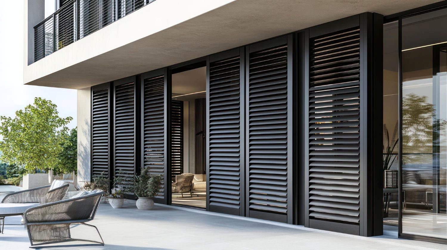 Modern balcony with dark louvred sliding screens and contemporary outdoor furniture.